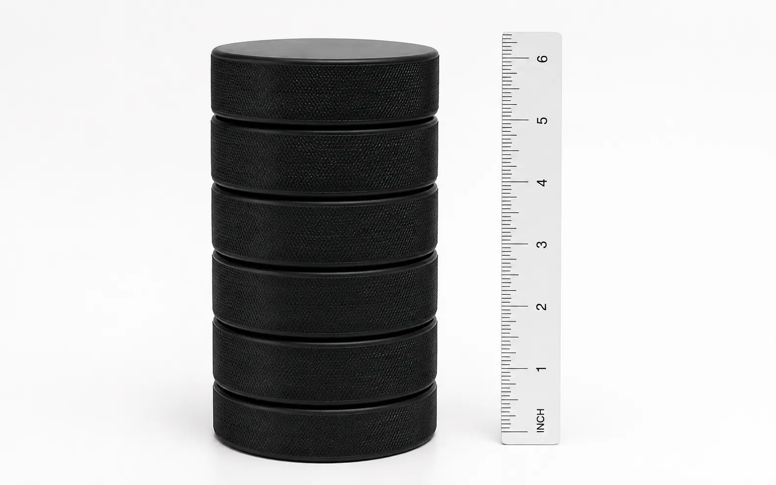 Six regulation hockey pucks stacked to a height of 6 inches Six regulation hockey pucks stacked to a height of 6 inches